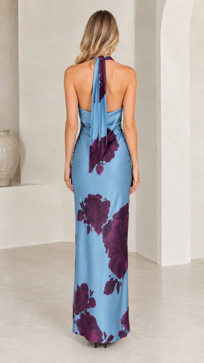 Back view of dusty blue halter maxi dress highlighting flowing tie-back scarf
