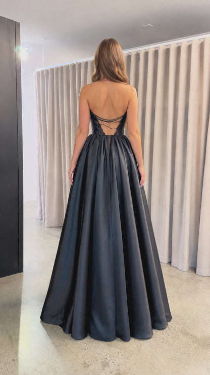 Back view of black satin evening gown showing lace-up strappy back