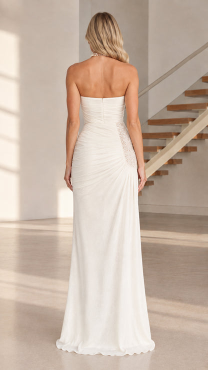 Back view of model in white strapless ruched floor-length dress