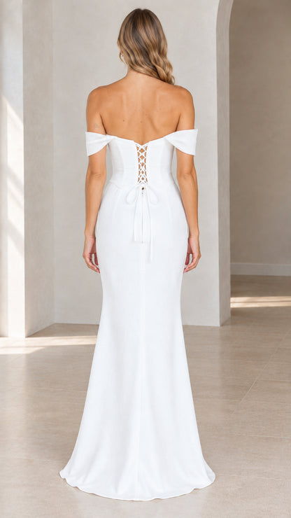 Back view of white formal gown showing corset lace-up tie detail