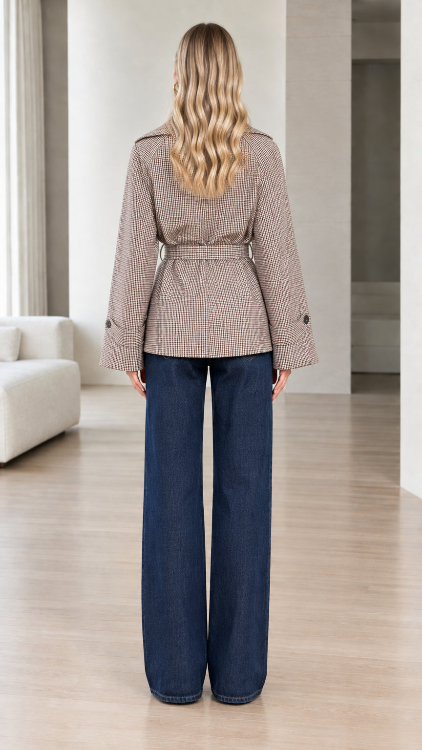 Back view of model wearing brown houndstooth belted jacket