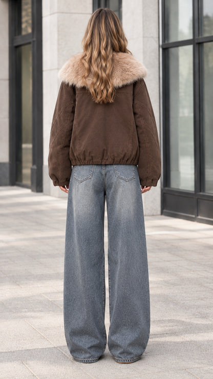 Back view of model wearing brown winter jacket showing relaxed fit and elastic hem