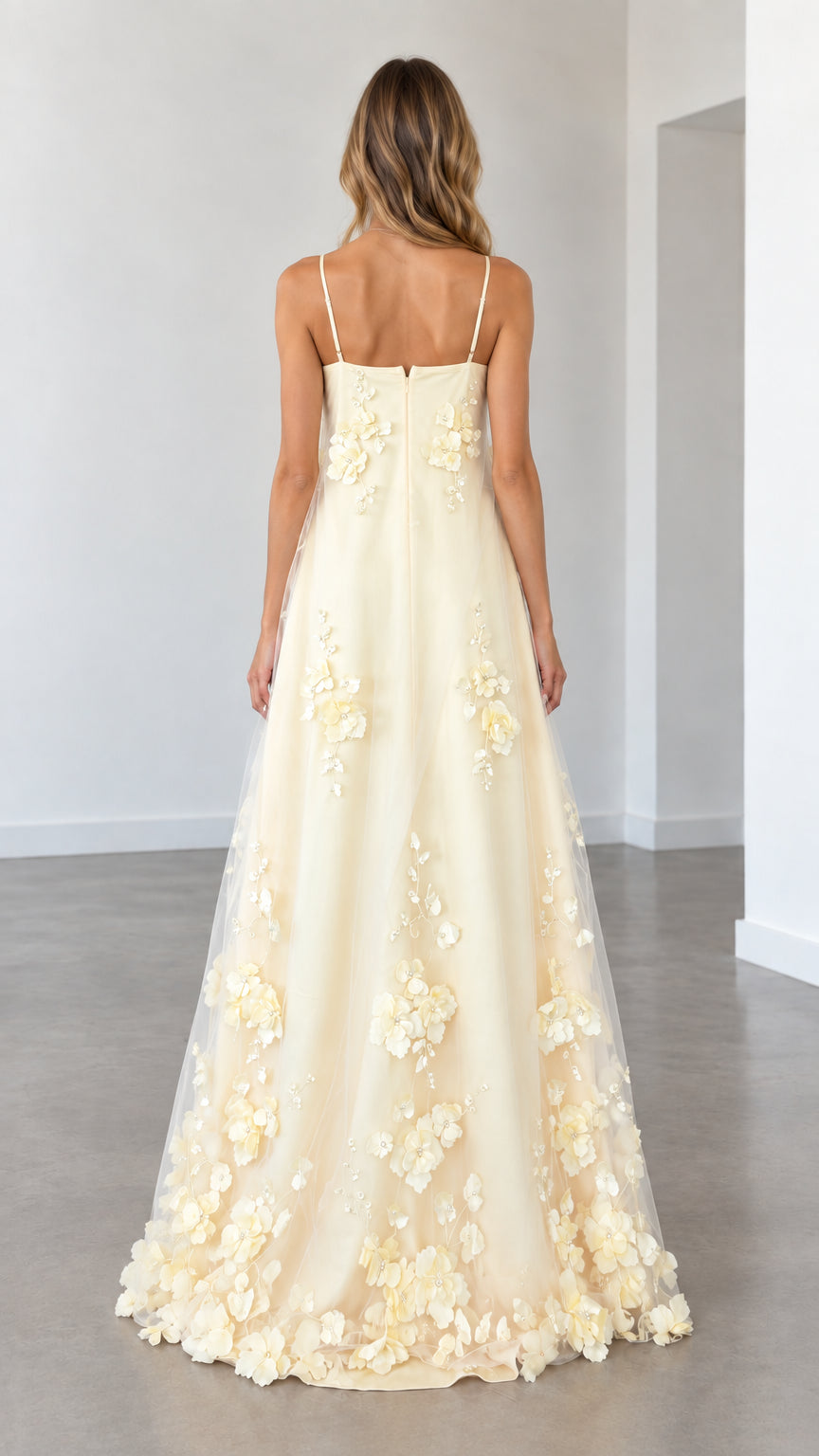 Model wearing butter yellow spaghetti strap evening gown back view