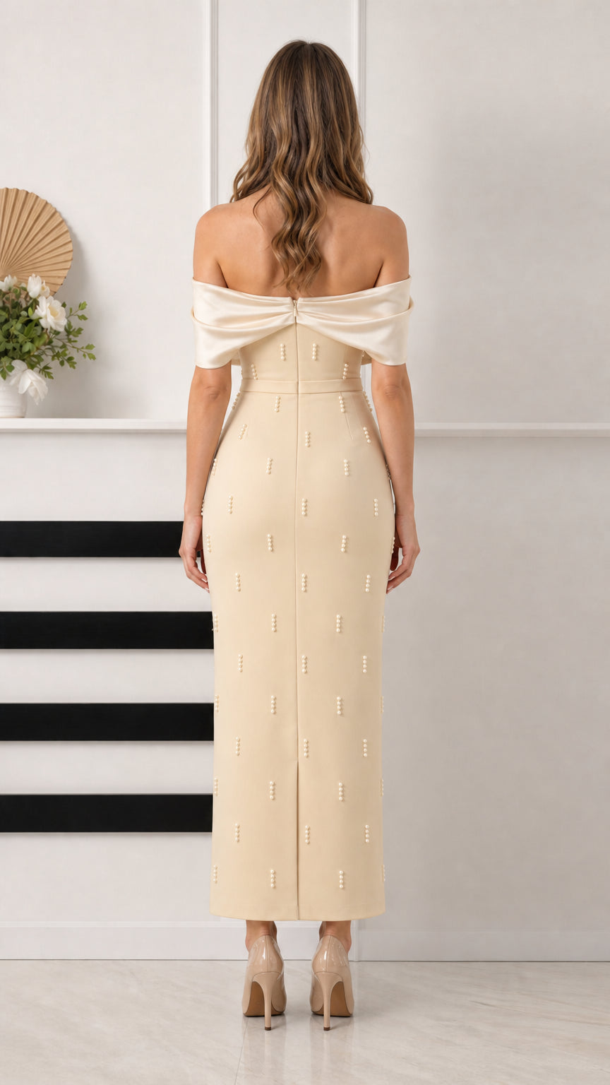 Back view of champagne column formal gown showing back slit and draped back sleeves