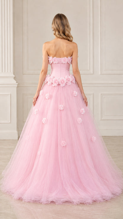 Back view of model in pink strapless corset-back tulle formal ball gown