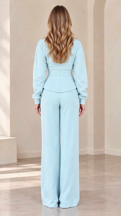 Back view of model in Light Blue corset-seamed jacket and wide-leg pants