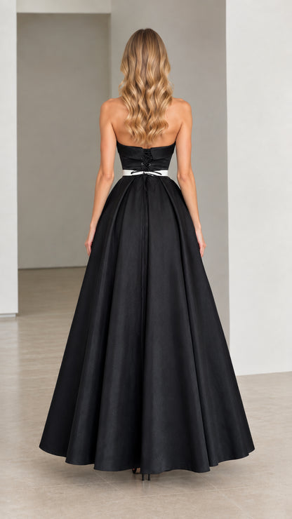 Rear view of strapless black gown showing lace-up corset back detail