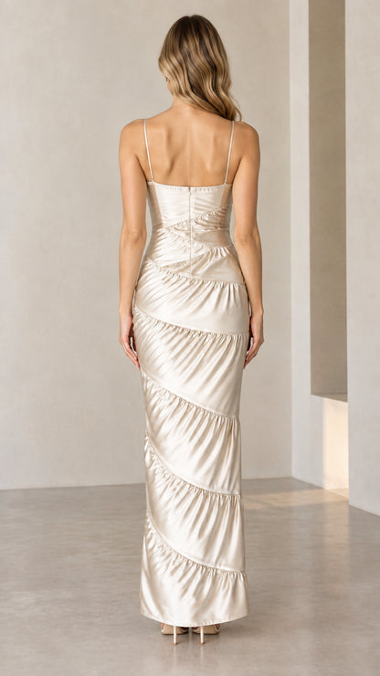 Back view of woman in Champagne spaghetti strap tiered satin gown