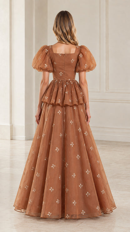 Back view of woman wearing toffee brown square back peplum evening maxi dress