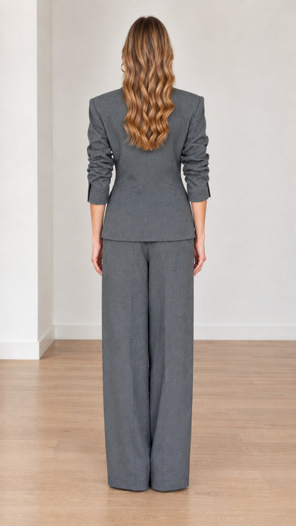 Back view of woman wearing Charcoal Grey tailored blazer and wide-leg pants