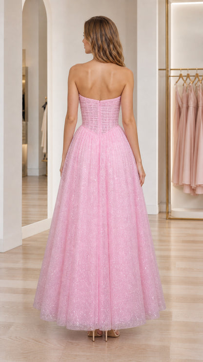Back view of model wearing pink strapless corset formal gown