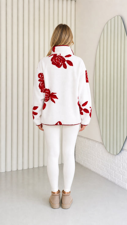 Back view of model wearing white and red floral plush fleece jacket