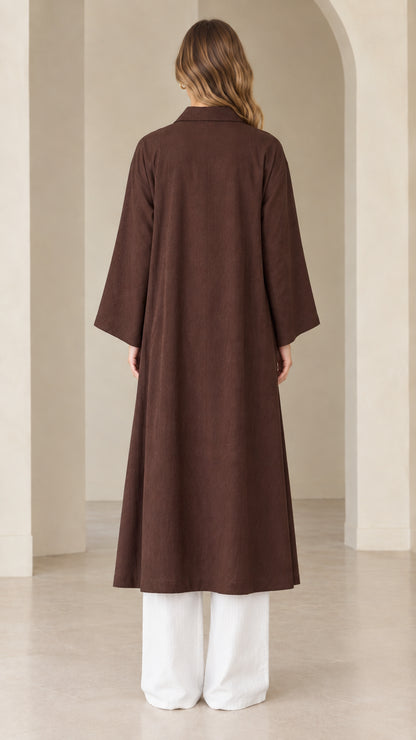 Back view of model wearing full-length dark brown open front duster coat