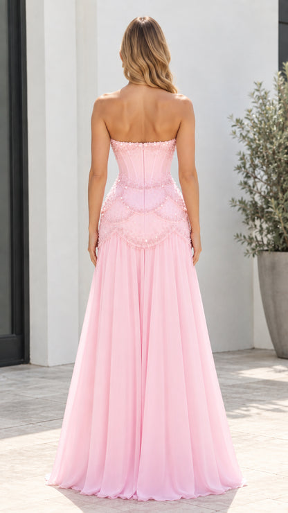 Back view of model showcasing the strapless corset back and pleated pink skirt