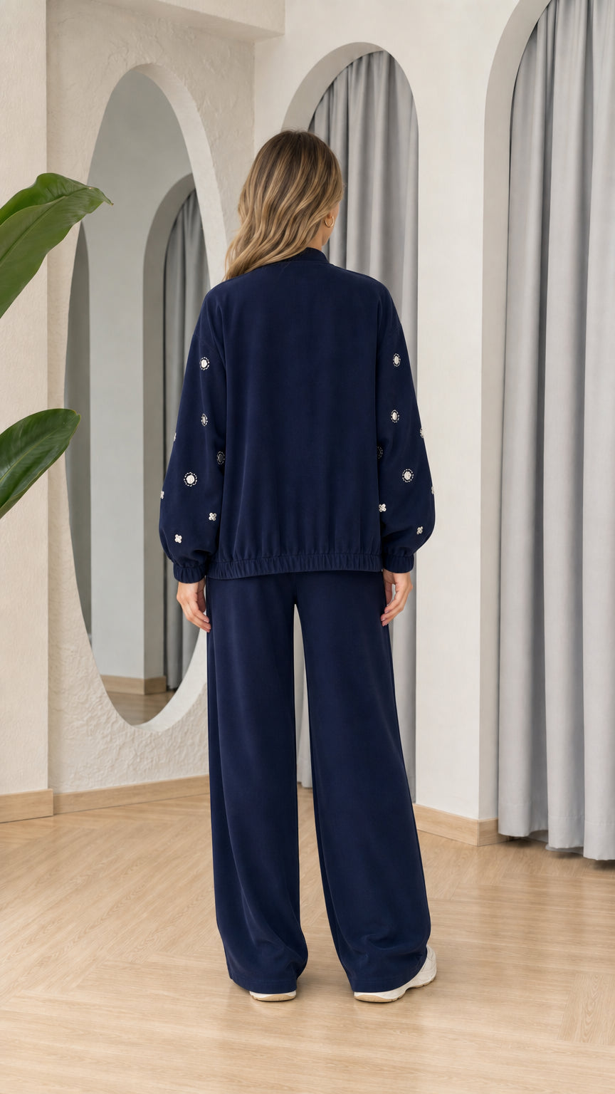 Model wearing Navy Blue wide leg pants and zip jacket set, back view