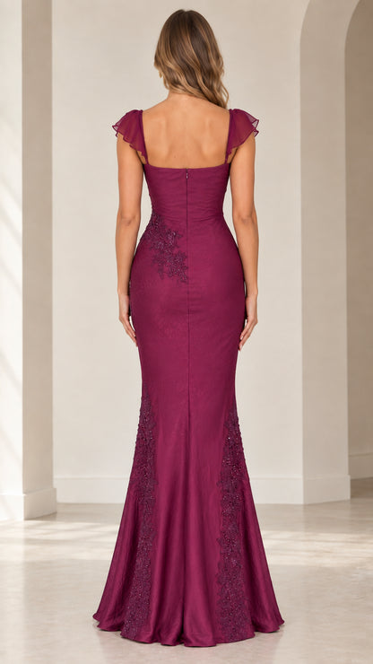 Back view of woman wearing magenta mermaid evening dress with square back and delicate flutter sleeves