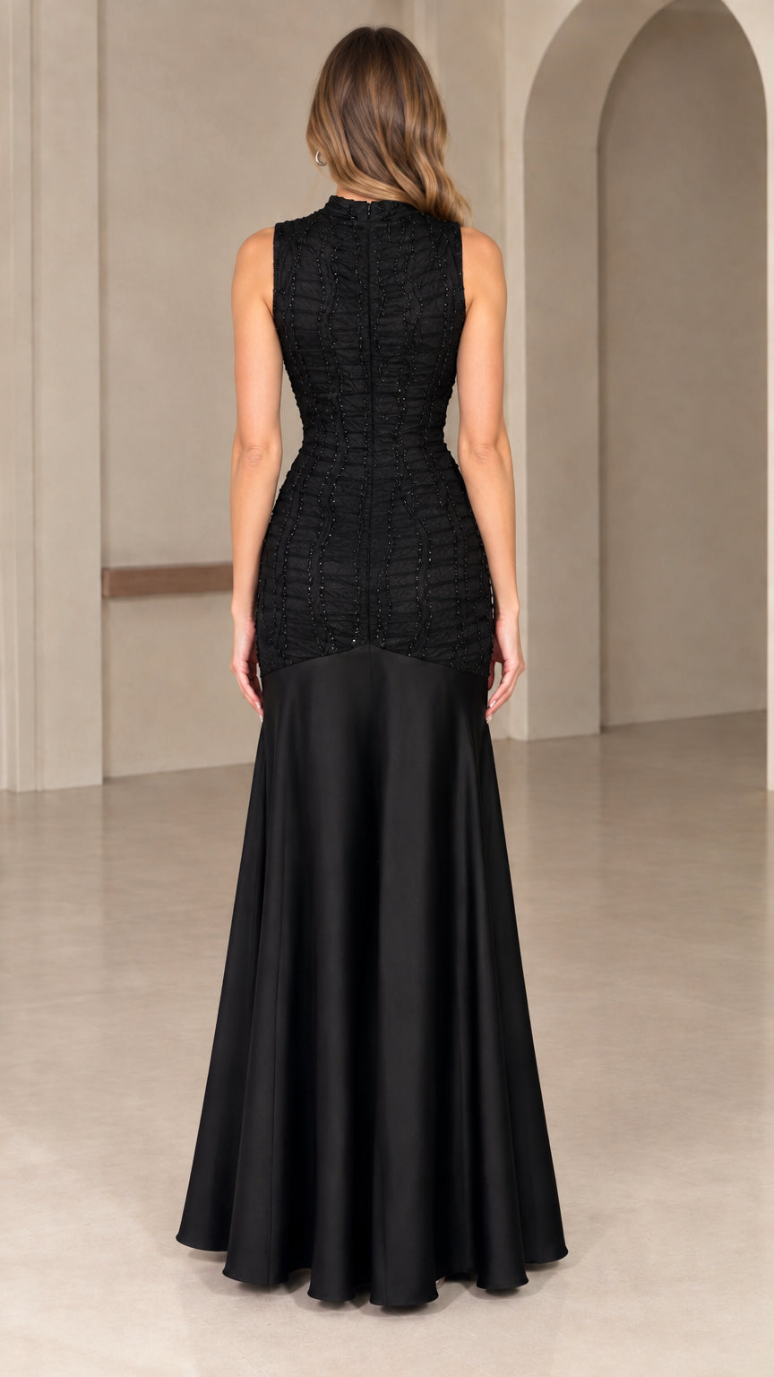 Back view of black high neck drop-waist evening dress with flared satin skirt