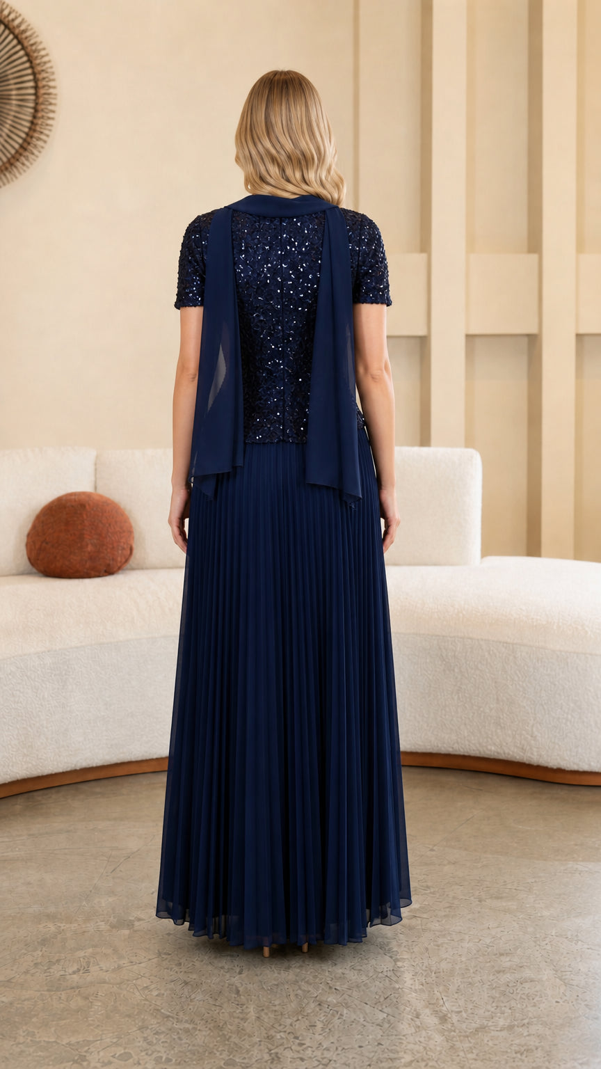 Model wearing Navy Blue sequined formal gown back view showing sheer scarf drape