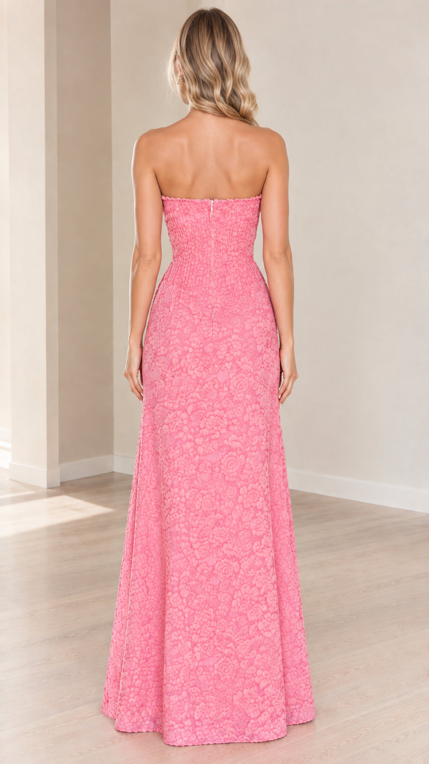 Back view of model wearing pink strapless floral textured maxi dress