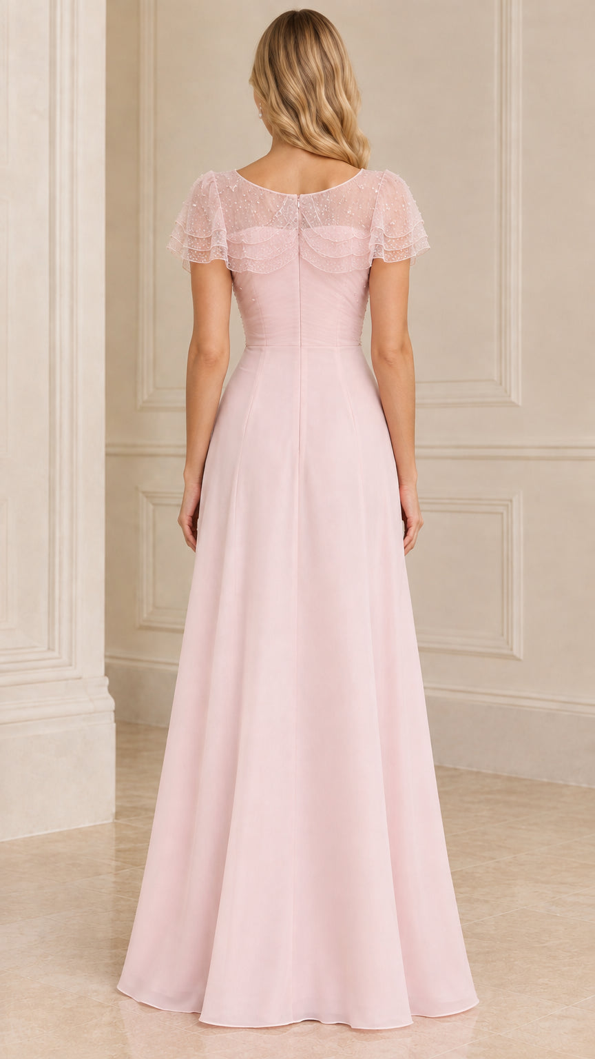 Back view of blush pink A-line evening gown with sheer shoulder cape
