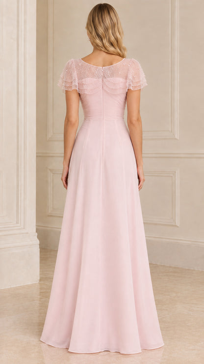 Back view of blush pink A-line evening gown with sheer shoulder cape