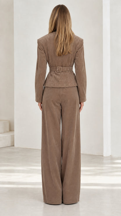 Back view of taupe corduroy suit set highlighting waist detailing and wide trouser fit