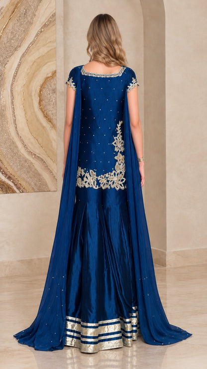 Back view of royal blue sharara suit set with flowing cape