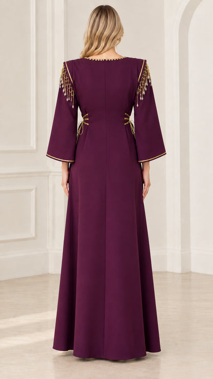 Back view of deep purple maxi dress showing clean tailored lines and shoulder fringe