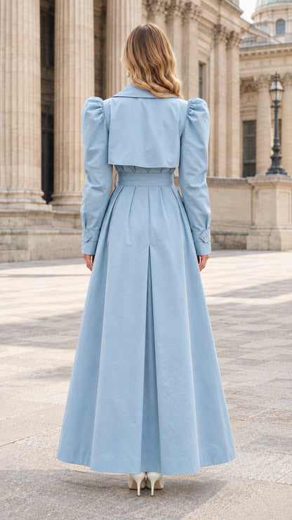 Back view of light blue maxi trench coat showing back flap and inverted pleat