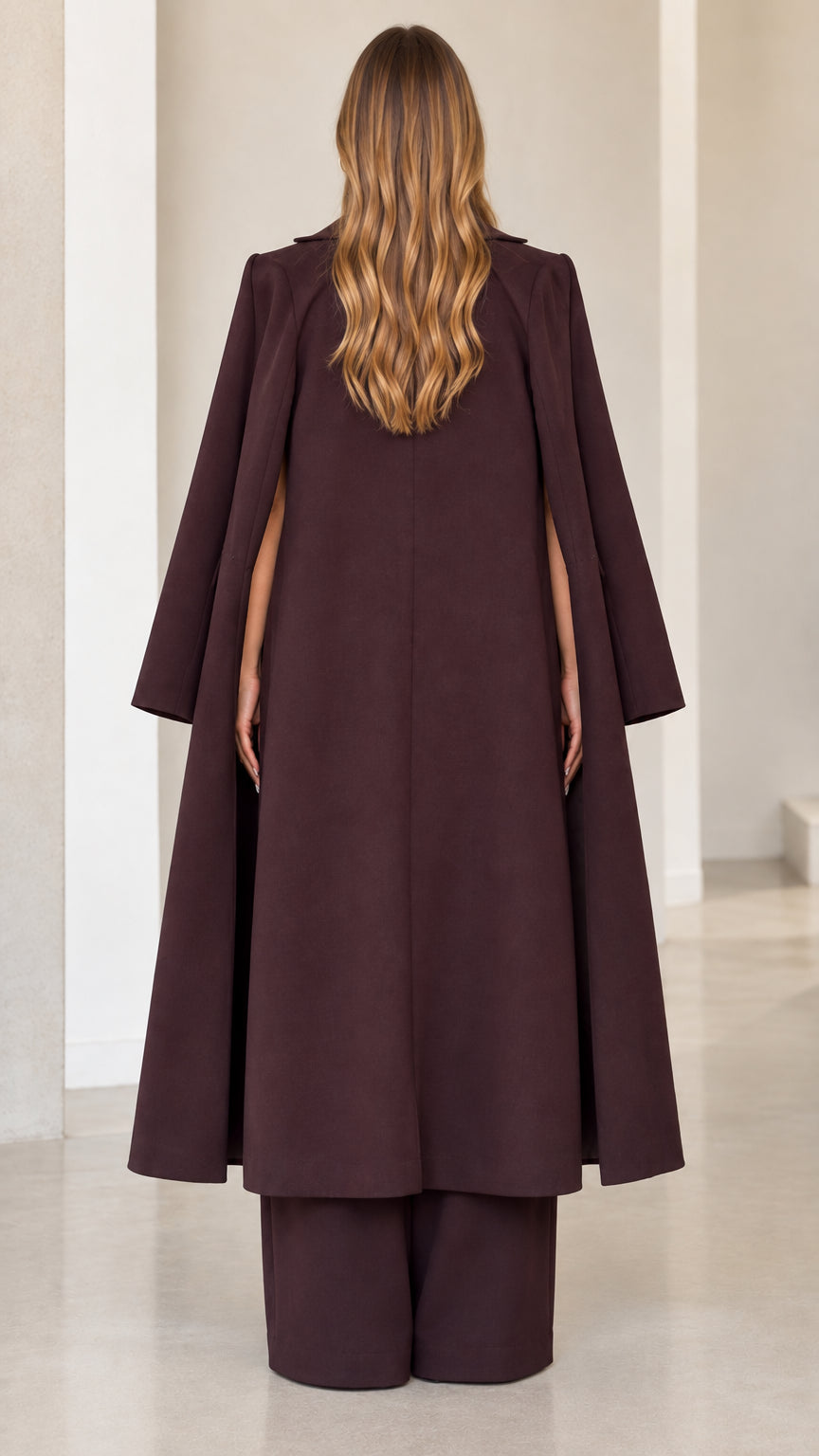 Burgundy longline cape coat back view showing slit sleeve cape detail