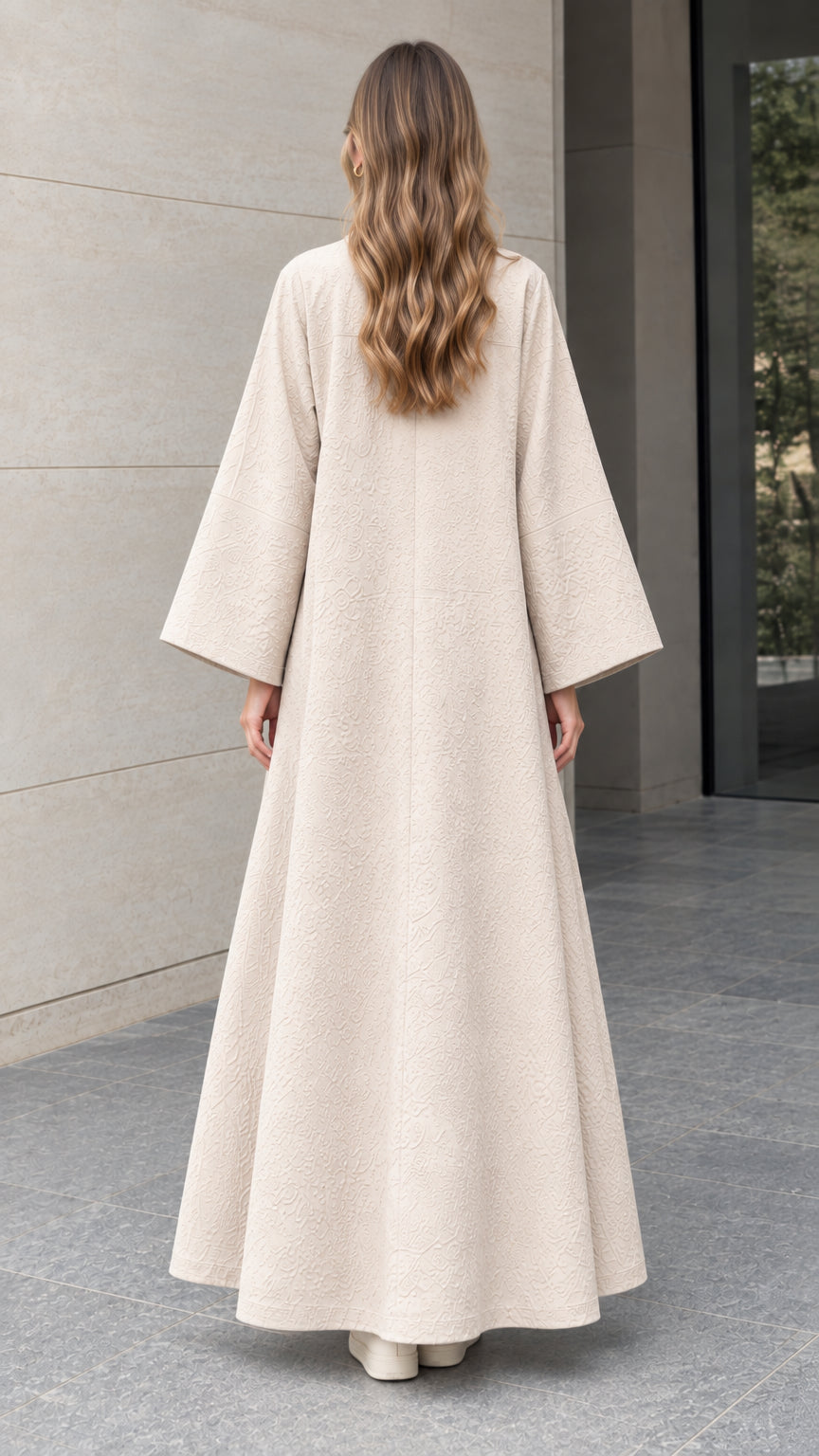 Back full-length view of woman wearing elegant beige floor-length jacquard duster