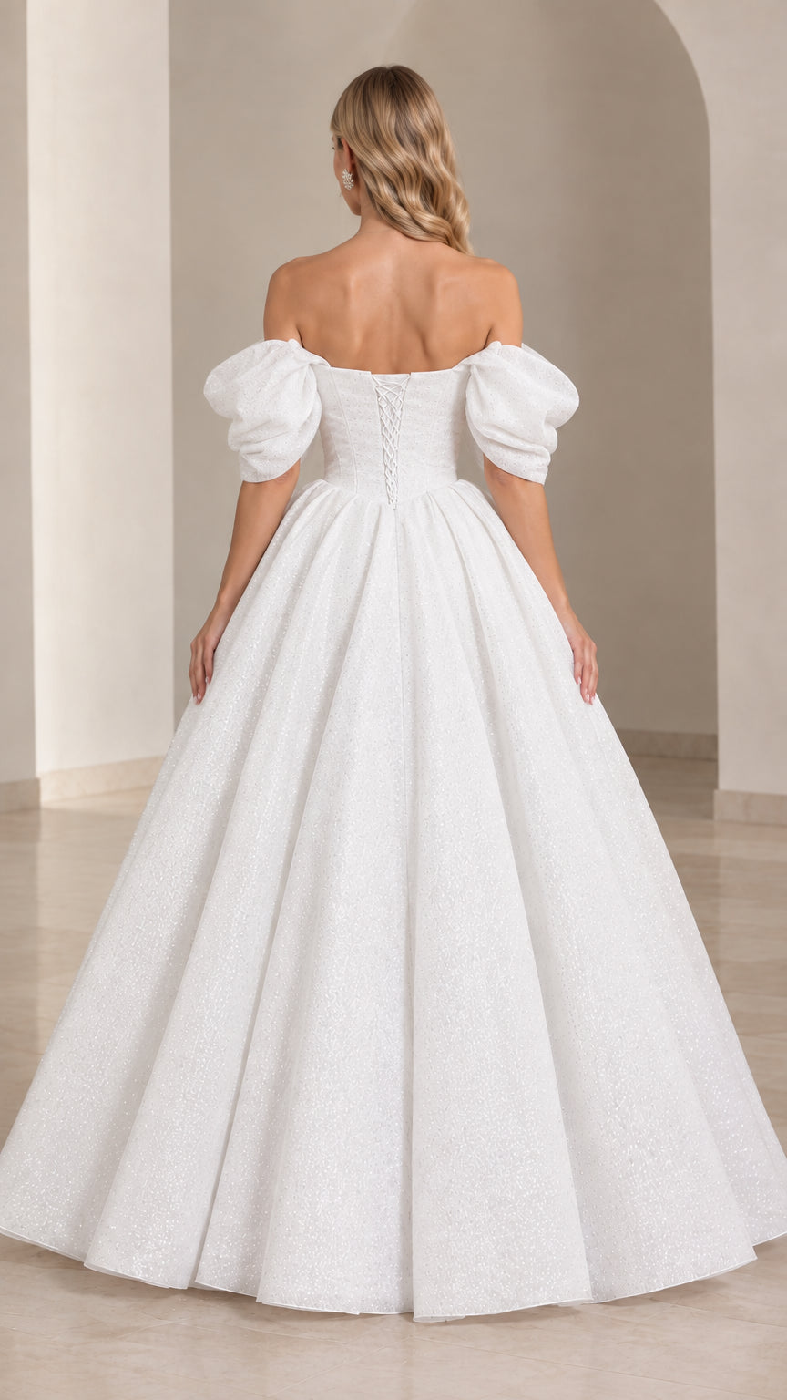 Back view of white formal gown showing lace-up corset detail