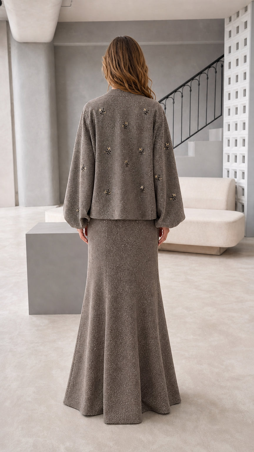 Back view of women's taupe long sleeve jacket and maxi skirt set