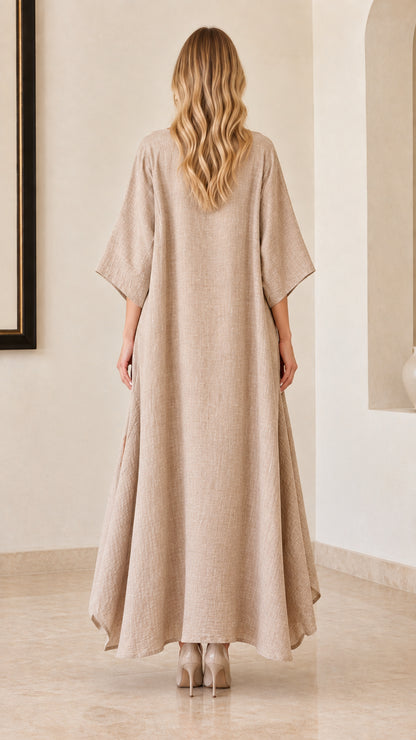 Back view of woman wearing beige relaxed kaftan maxi dress