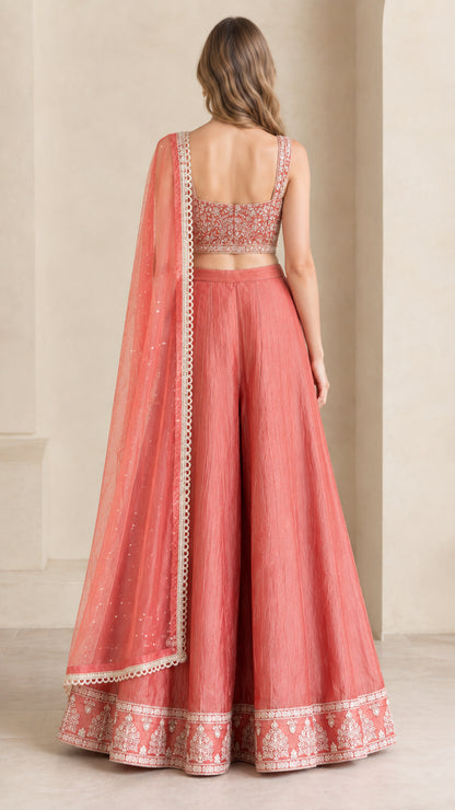 Back view of coral pink crop top and flowing wide-leg pants set with dupatta