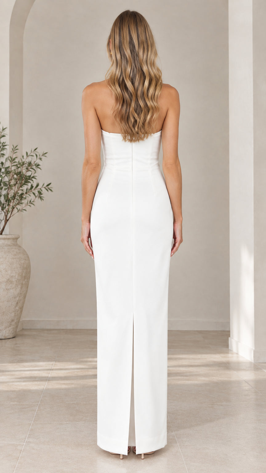 Back view of white strapless column dress showing back slit