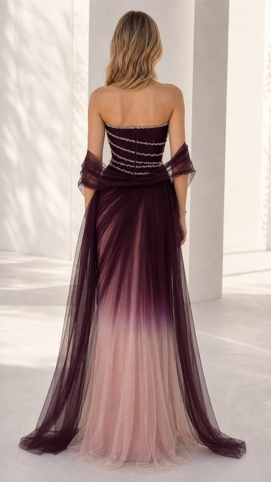 Back view of the burgundy ombre tulle gown showcasing the strapless back and flowing sheer shawl