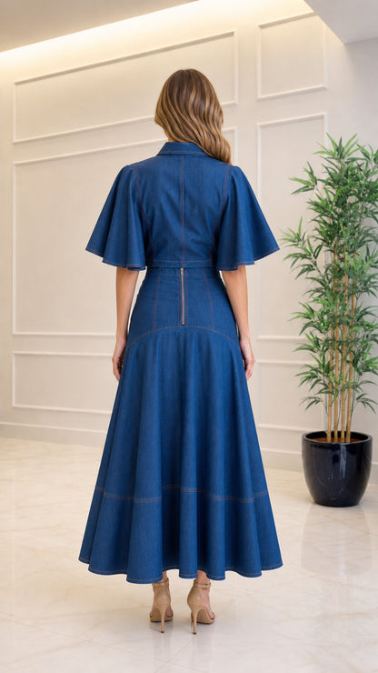 Back view of model showing exposed back zipper on denim blue maxi dress