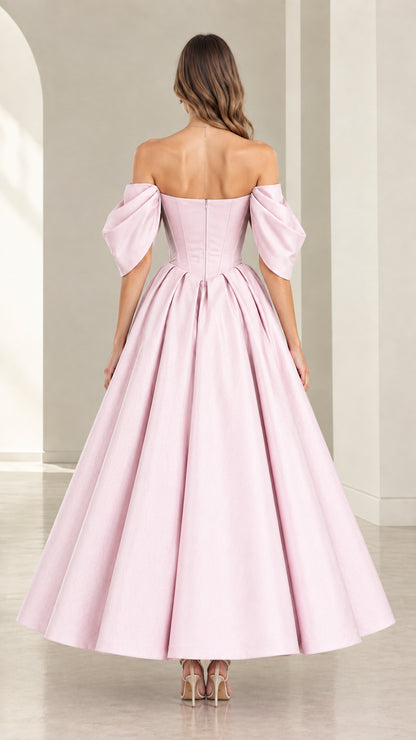 Back view of model showcasing Blush Pink corset back and pleated skirt