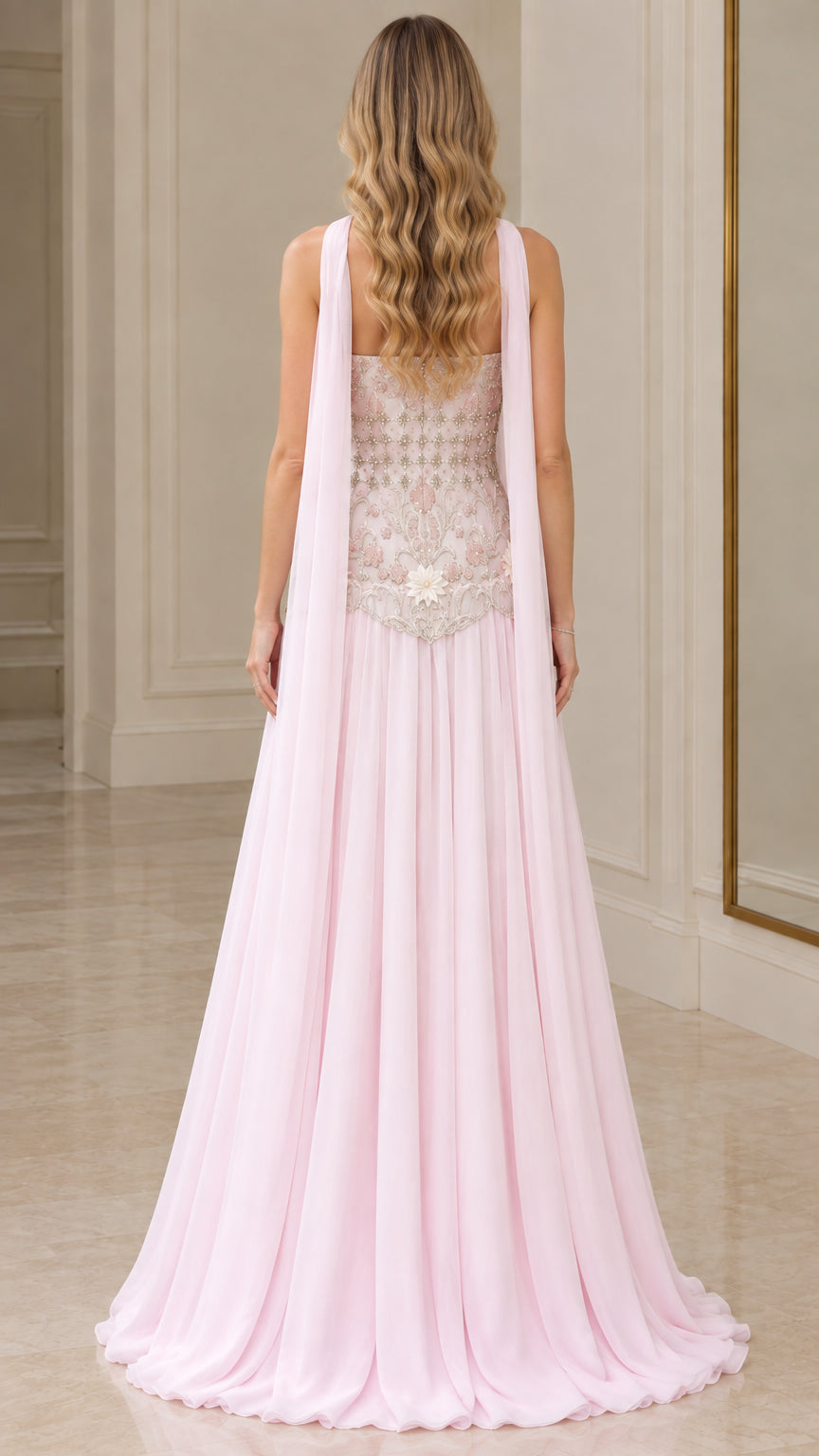 Back view of blush pink floor-length evening gown showing cascading back cape streamers