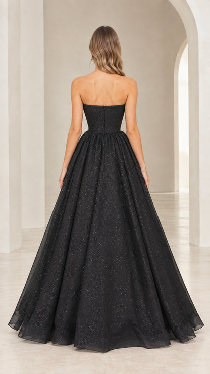 Back view of black strapless floor-length glitter ball gown