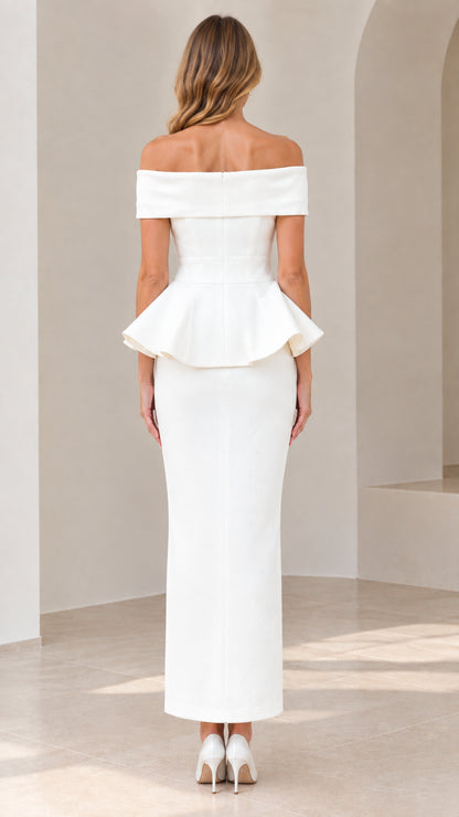 Back view of model showing tailored fit and peplum detail on white maxi dress