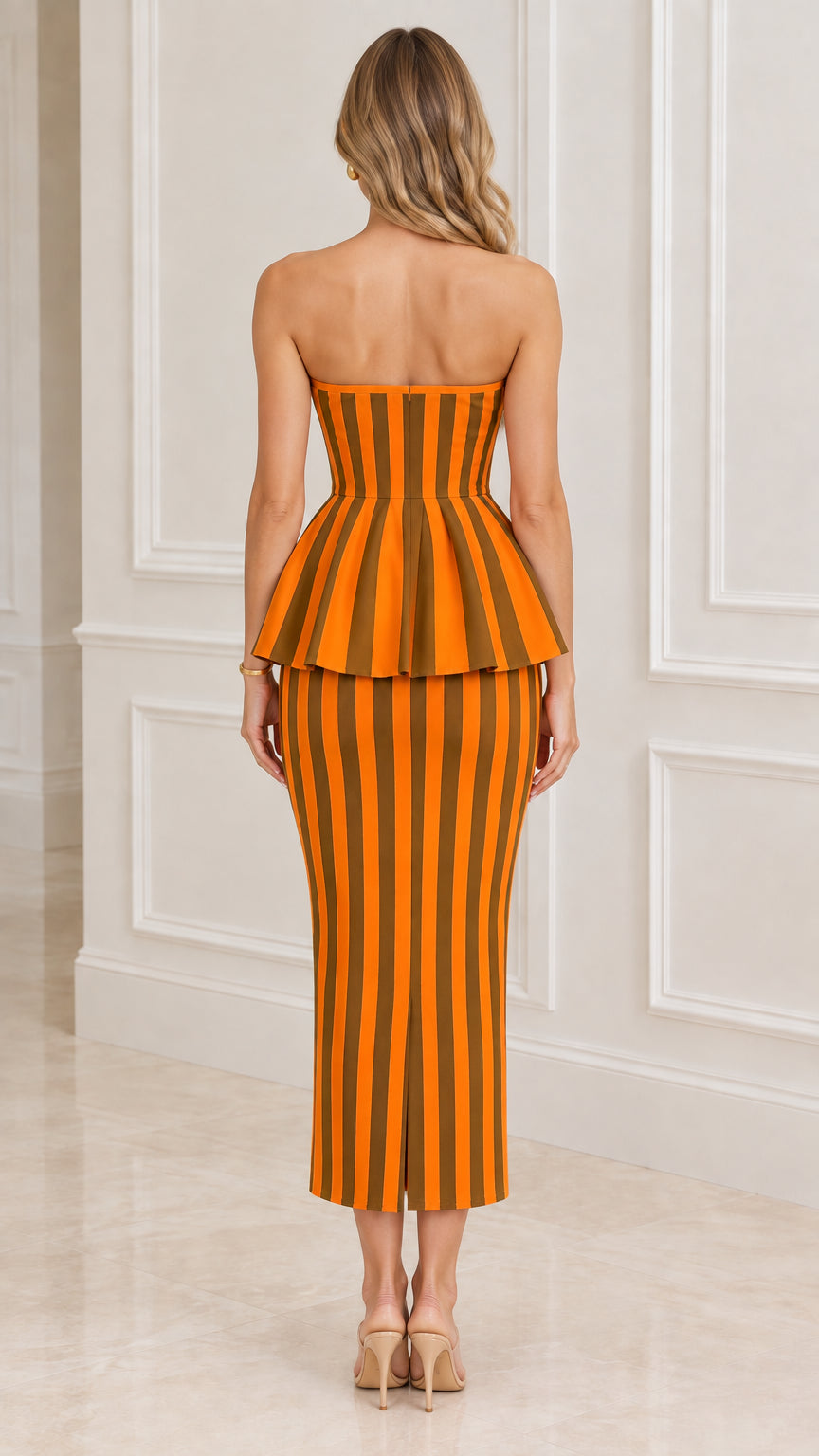 Back full-length view of the strapless orange striped peplum midi dress