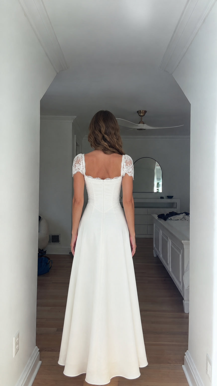 Back view of white lace trim corset maxi dress showing open back neckline