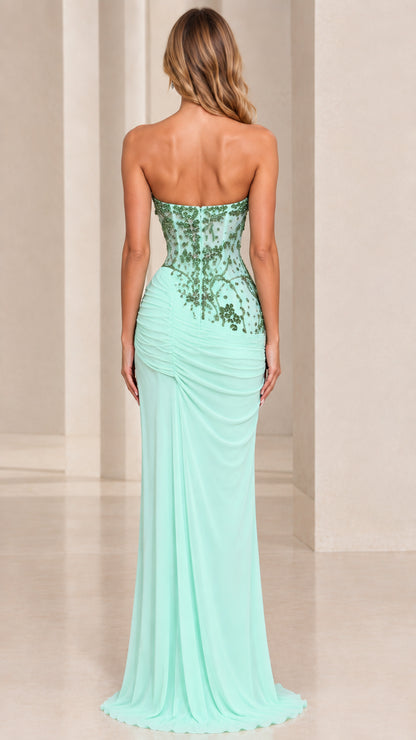 Back view of model in mint green strapless back embellished evening gown