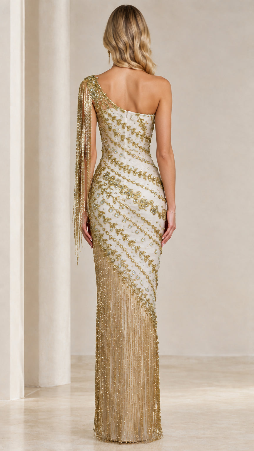 Back full-length view of Ivory Gold one-shoulder gown with diagonal beading and fringe hem