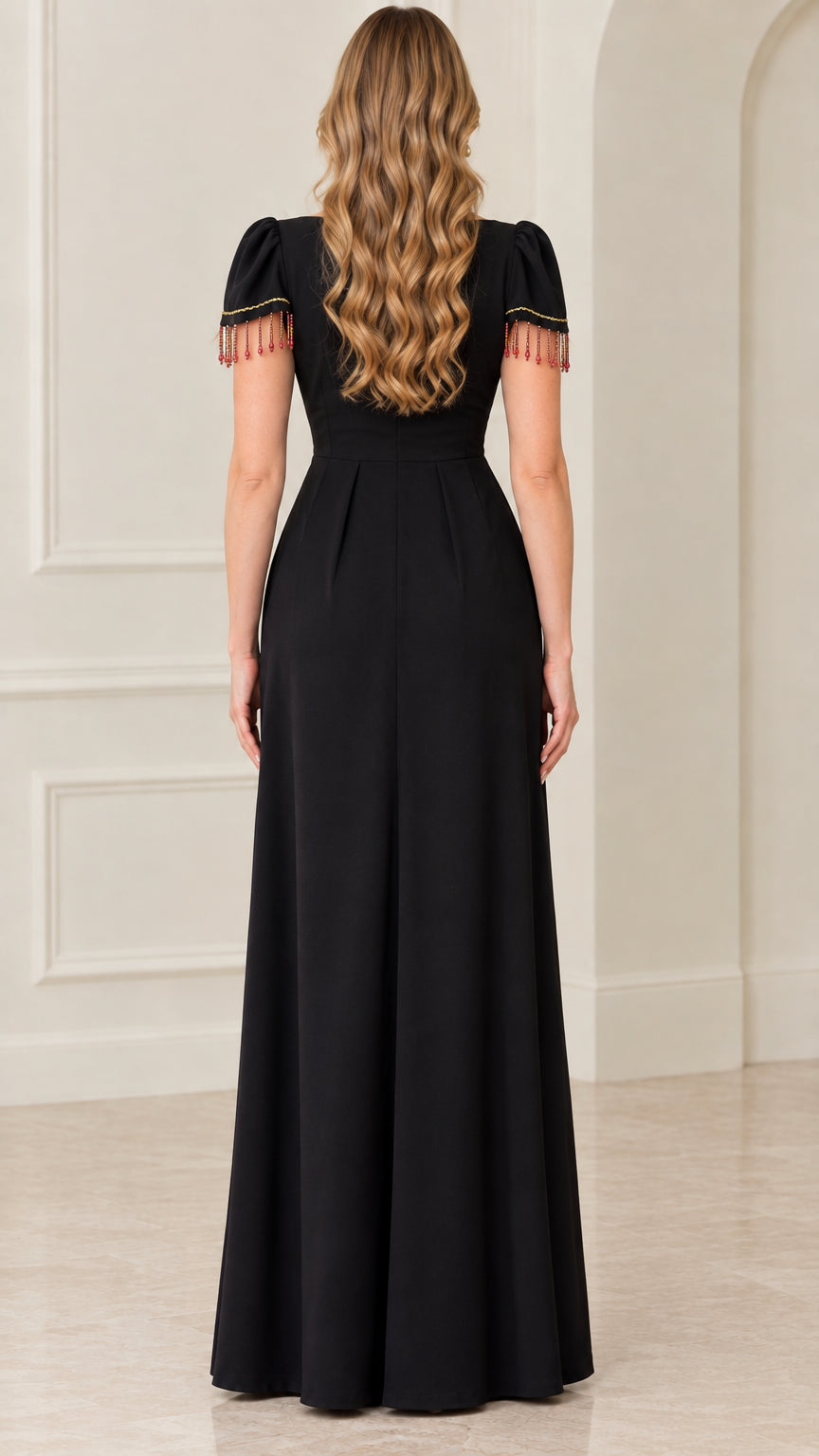 Back view of black floor-length gown showing clean zipper closure and pleat details