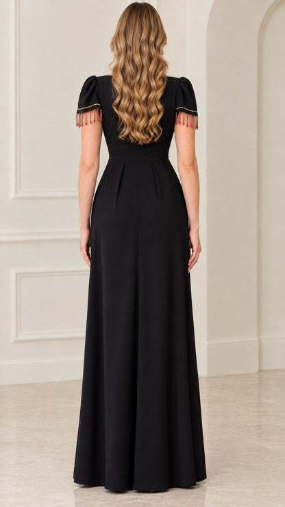 Back view of black floor-length gown showing clean zipper closure and pleat details