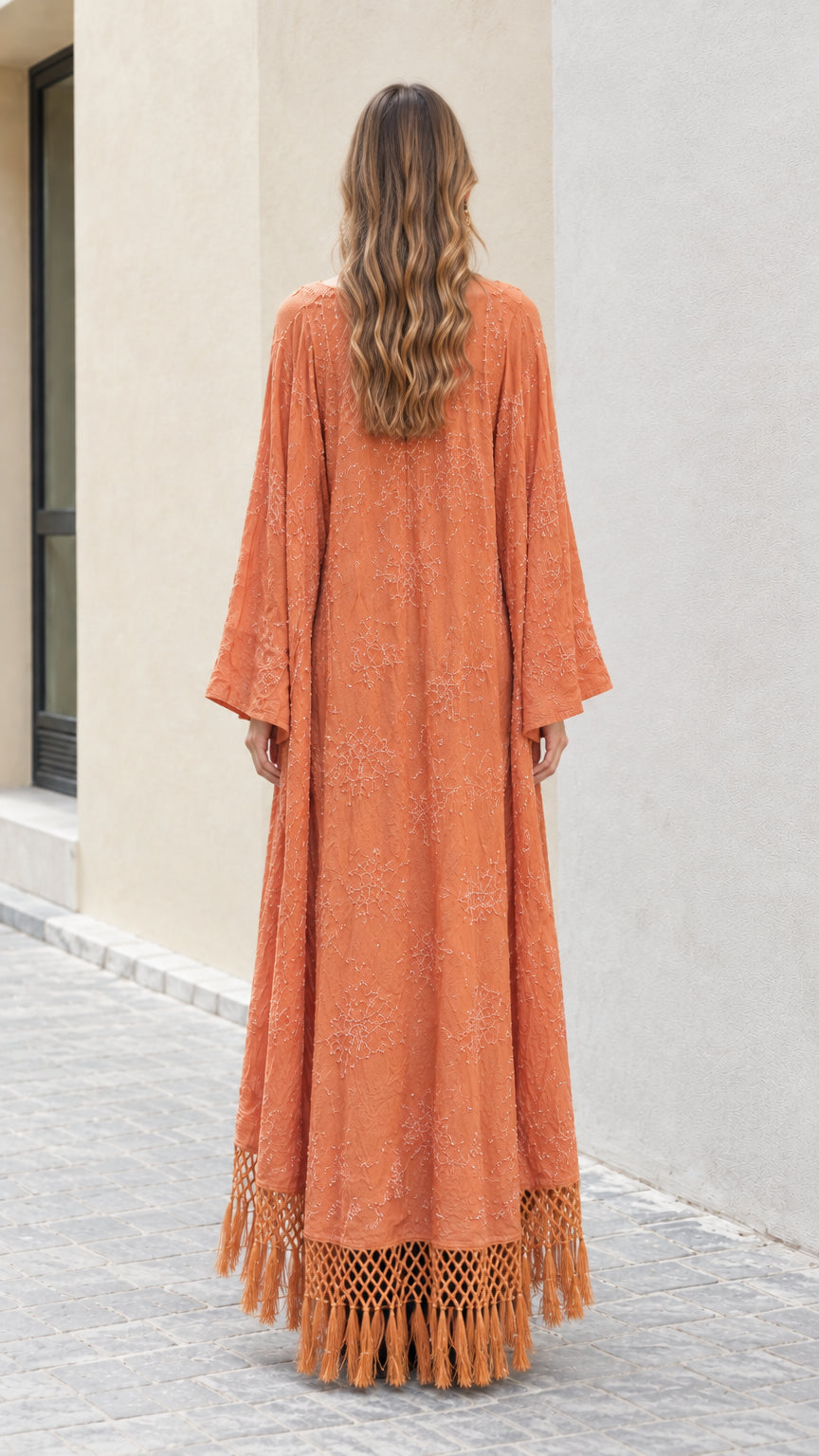 Back view of rust orange maxi kimono cardigan showing full length and fringe hem