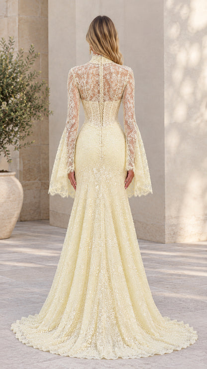 Back view of model in light yellow lace evening gown featuring sheer back and sweep train